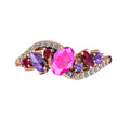 Top view of the Atlantis Storm 18ct rose gold ring featuring a central pink sapphire, rubies, and violet sapphire accents.