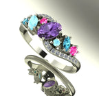 Angled shot of the handmade Atlantis Storm ring showcasing the sparkle and three-dimensional cluster of sapphires and zircons. Shaded background.