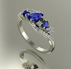 Side view of the white gold Atlantis Storm ring, highlighting the organic wave setting and sapphire cluster.