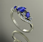 Side view of the white gold Atlantis Storm ring, highlighting the organic wave setting and sapphire cluster.