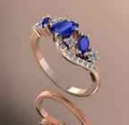 Side profile view of the rose gold Atlantis Storm ring, showcasing the organic wave setting and multi-gemstone cluster.