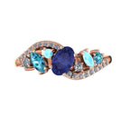 Top-down view of the Atlantis Storm 18ct rose gold ring featuring a central tanzanite, blue diamonds, and aquamarine accents.