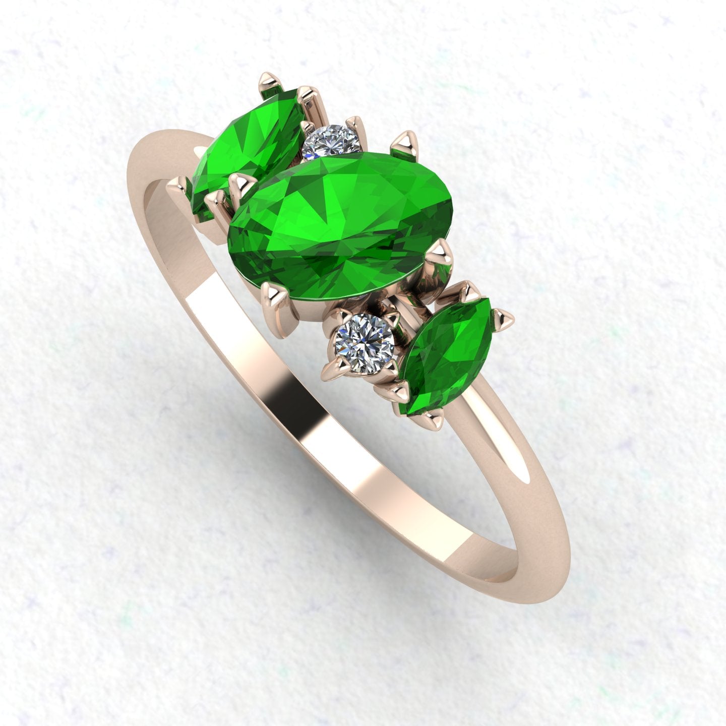 An angled perspective of the Atlantis ring, showcasing the organic, contemporary design and the striking contrast of green garnets against the rose gold band.