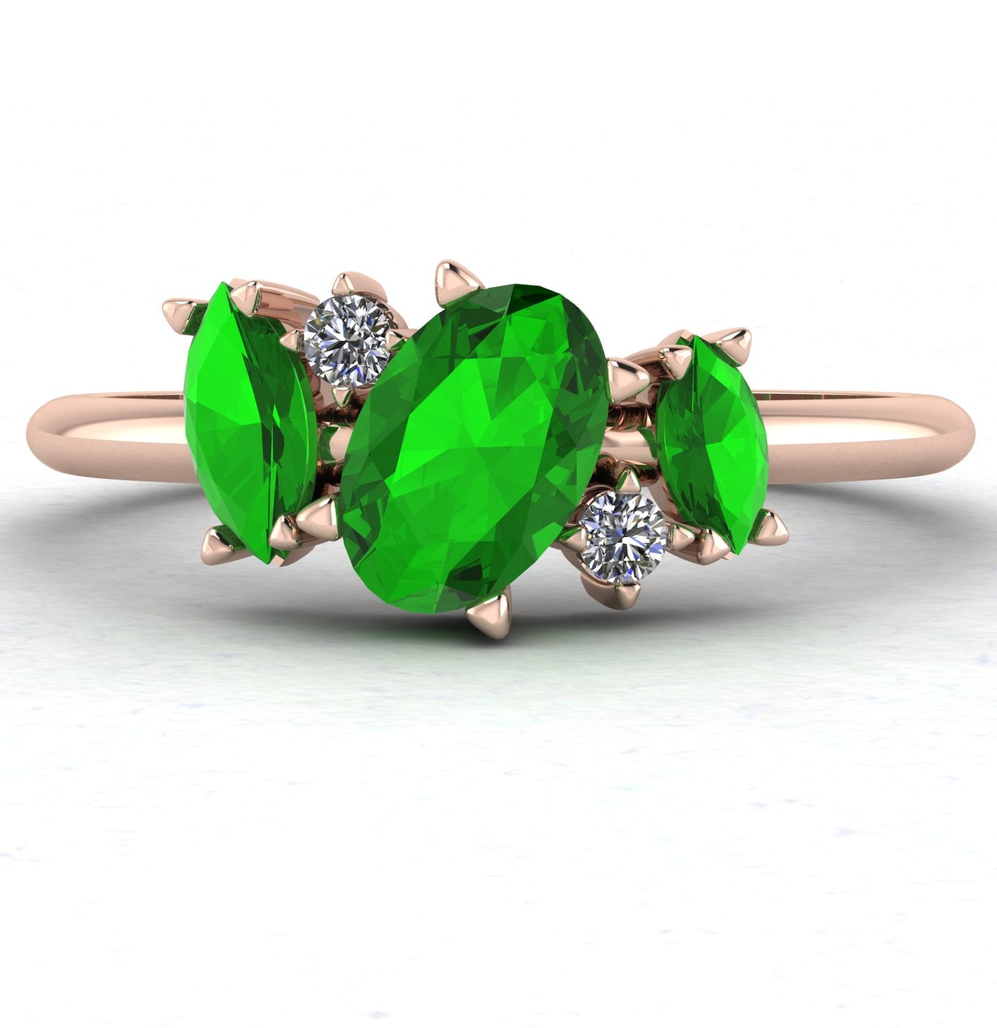 Front view of the Atlantis engagement ring, featuring an asymmetrical cluster of vivid green tsavorite garnets and sparkling diamonds in 18ct rose gold.