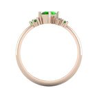 A view looking through the 18ct rose gold band, detailing the intricate under-gallery and the secure mounting of the tsavorite garnet and diamond cluster.