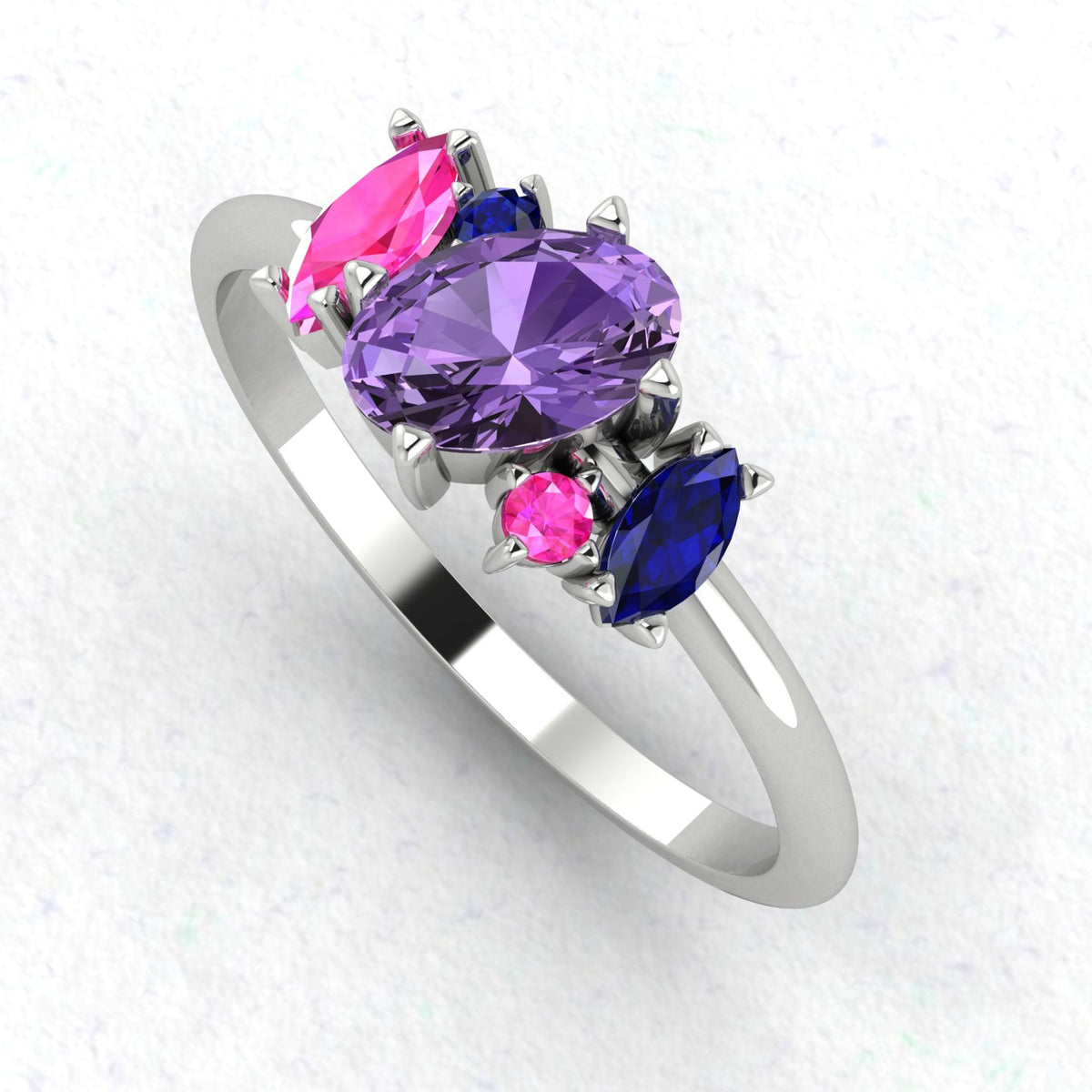 Atlantis violet, pink and blue sapphire asymmetrical engagement ring in white gold or platinum, angled view showing the contemporary cluster setting and polished band, handmade in London
