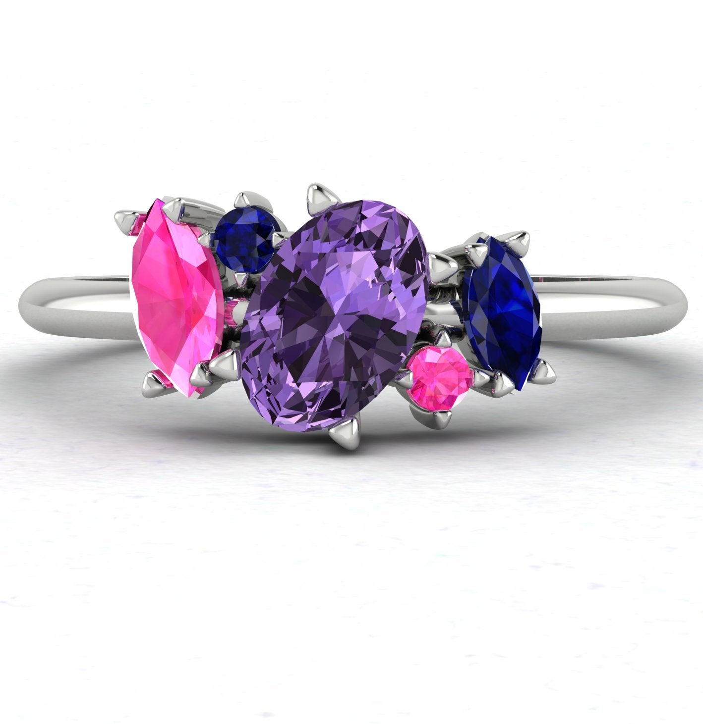 Atlantis violet, pink and blue sapphire asymmetrical engagement ring in platinum or 18ct white gold, front view showing the organic multi-sapphire cluster, handmade in our London studio