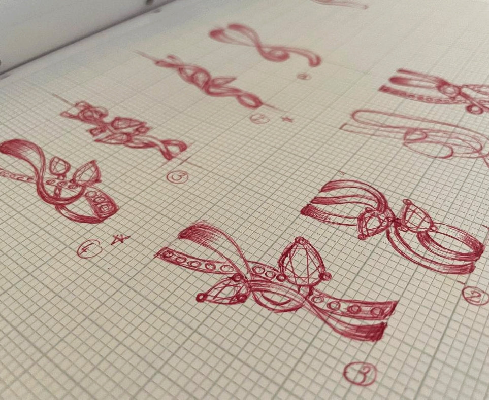 Red ink sketches of unique and bespoke engagement ring designs for a client.