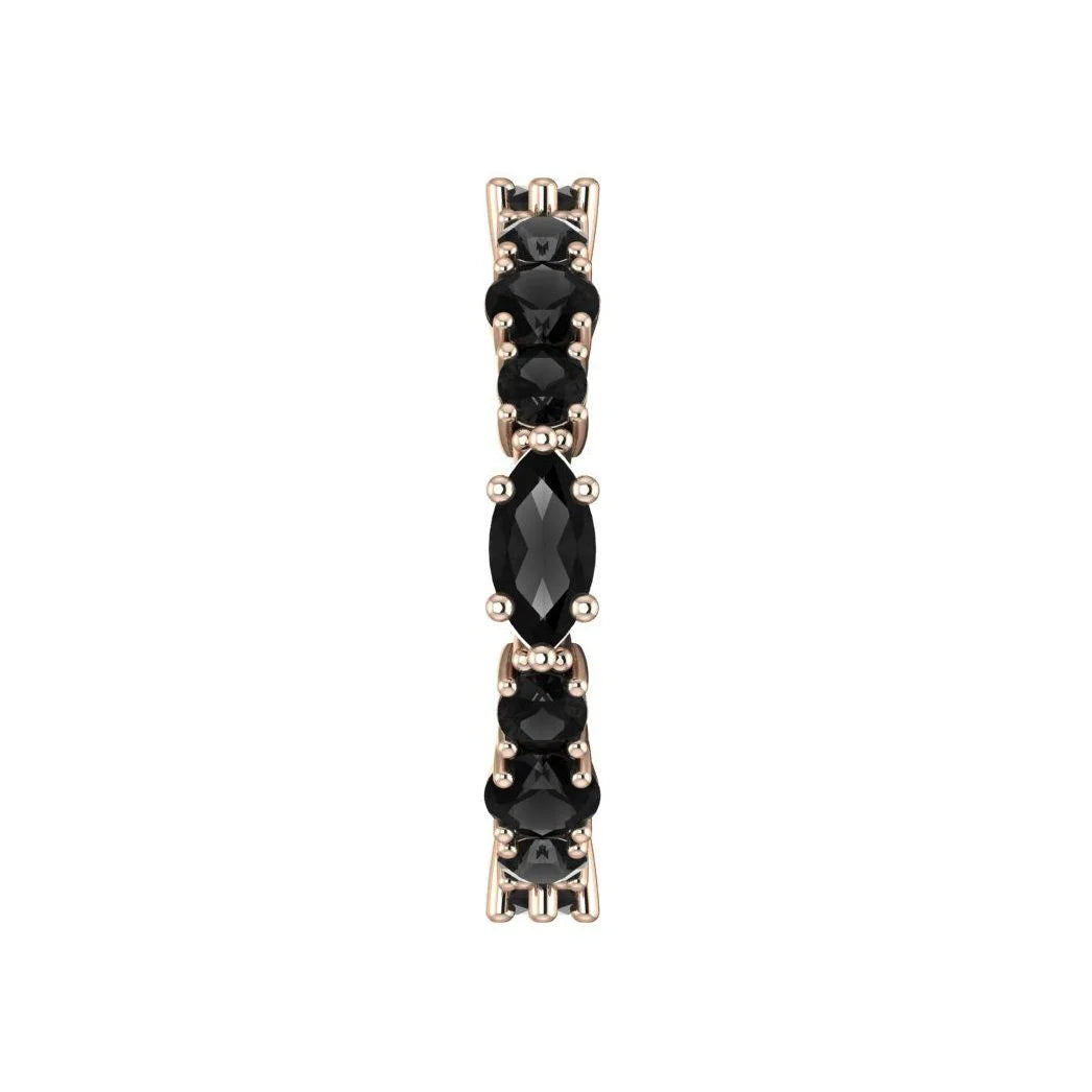 Detailed side view of the handcrafted 18ct rose gold finish against the deep black gemstones.