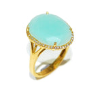 Large cabochon cut blue chalcedony ring set in 18ct yellow gold with a brilliant cut diamonds halo.