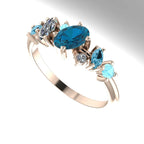 An angled view of the Atlantis Paradise ring highlighting the three-dimensional layout of the blue topaz and diamonds.