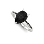 Front three-quarter studio view of the Calista 2ct black diamond ring, highlighting the striking contrast of dark gemstones against a white precious metal band.