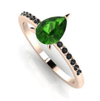 Front three-quarter studio view of the Calista tourmaline ring, showcasing the dark, edgy contrast of the black diamonds set into the rose gold shoulders.