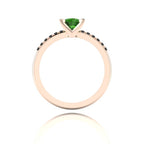 Through-finger view of the 18ct rose gold tourmaline ring, showing the clean interior under-gallery and precise black diamond settings.