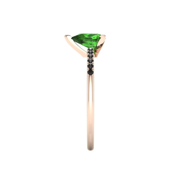 Side profile product photo of the Calista ring, displaying the elegant, structural three-prong basket setting holding the pear green tourmaline.