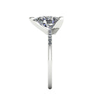 Side profile product photo of the Calista ring, displaying the elegant, structural three-prong basket setting holding the pear diamond.