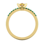 Through-finger technical view of the 18ct gold Calista sapphire and emerald ring, showing the clean under-gallery and UK hallmark.