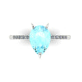 Top-down studio hero shot of the Calista engagement ring, featuring a massive 1.9-carat pear-shaped aquamarine framed by brilliant white diamonds.
