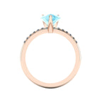 Through-finger view of the 18ct rose gold aquamarine ring, showing the smooth interior under-gallery and precise stone settings.