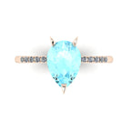 Top-down studio hero shot of the Calista engagement ring, featuring a vibrant 2-carat pear-shaped aquamarine on a polished 18ct rose gold band with sparkling diamond shoulders.