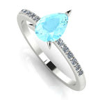 High angle studio detail shot of the Calista engagement ring, showing the crisp clarity and watery blue reflection through the facets of the aquamarine.