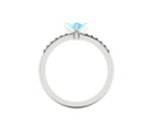 Through-finger view of the white gold or platinum aquamarine ring, displaying the pristine interior under-gallery and precise stone settings.
