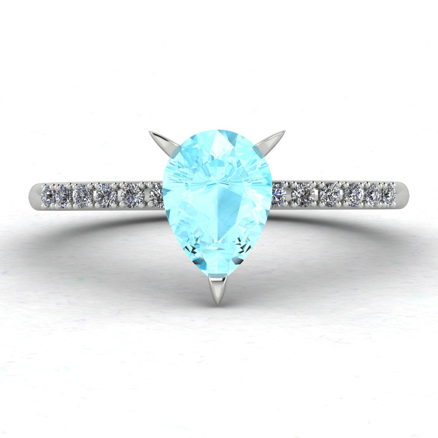 Front three-quarter studio view of the Calista aquamarine ring, highlighting the brilliant white pavé diamonds set into the polished white metal shoulders.
