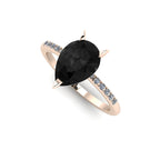 Front three-quarter studio view of the Calista black diamond ring, highlighting the beautiful contrast of the white pavé diamonds set into the warm rose gold shoulders.