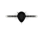 Top-down studio hero shot of the Calista ring, showcasing a striking pear-shaped black diamond on a band with pave-set white diamond shoulders.