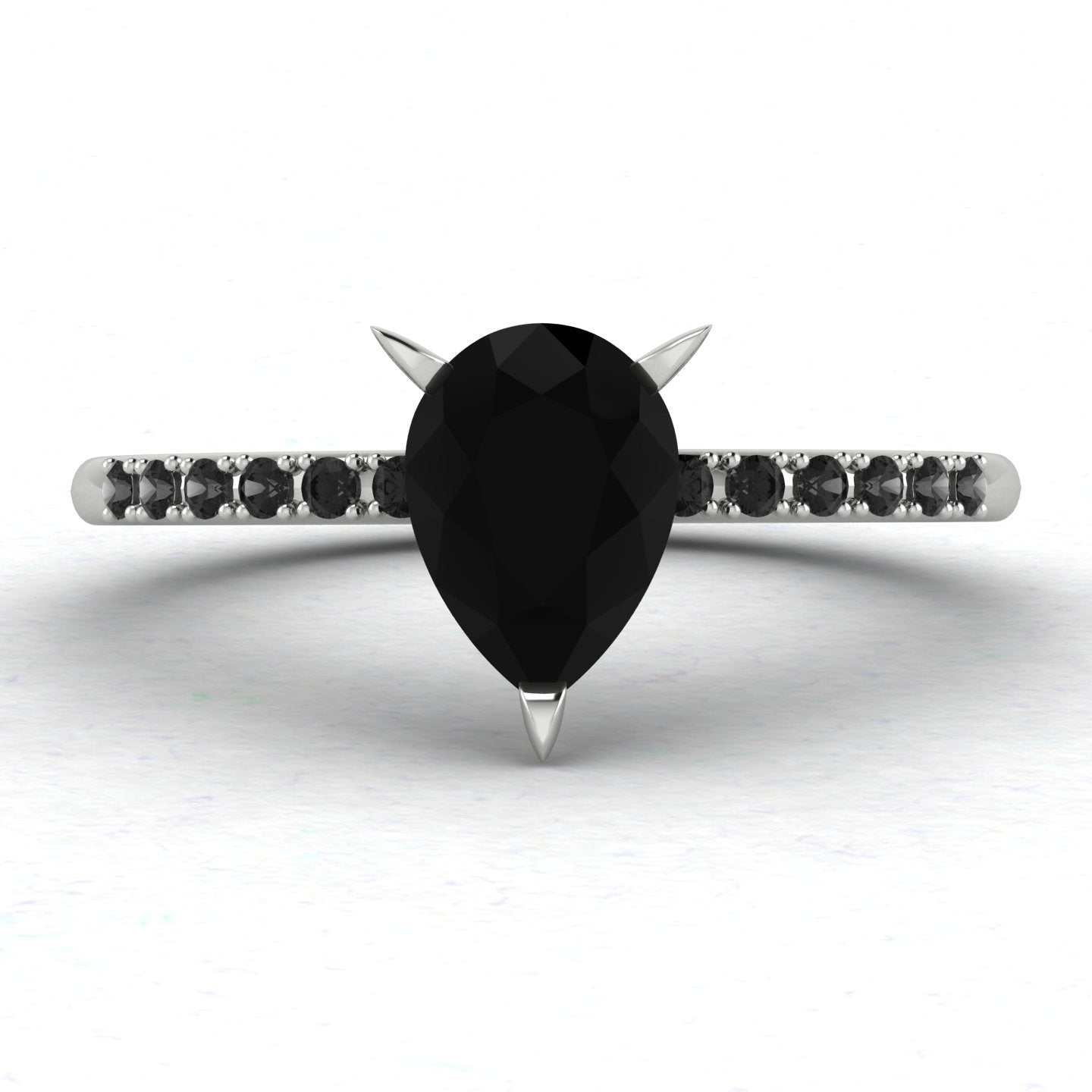 Front studio hero shot of the Calista ring, showcasing a striking pear-shaped black diamond on a band with pave-set white diamond shoulders.