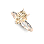 High angle studio detail shot of the Calista alternative engagement ring, showing the rich golden depth and exceptional facet light reflections within the champagne diamond.