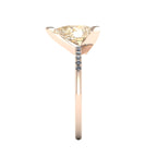 Side profile product photo of the Calista ring, displaying the clean, secure three-prong claw basket setting holding the 2-carat pear champagne diamond.