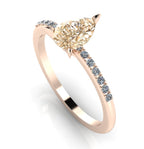 Front three-quarter studio view of the Calista champagne diamond ring, highlighting the brilliant white pavé diamonds set into the warm rose gold shoulders.