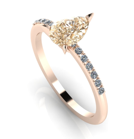 Front three-quarter studio view of the Calista champagne diamond ring, highlighting the brilliant white pavé diamonds set into the warm rose gold shoulders.
