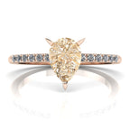 Front studio hero shot of the Calista ring, showcasing a prominent pear-shaped champagne diamond on a rose gold band with white diamond shoulders.
