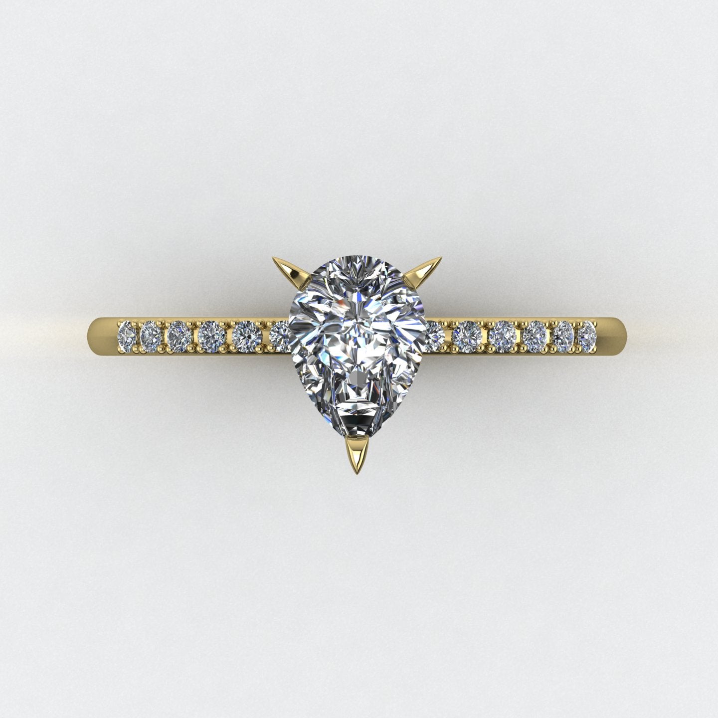 Calista engagement ring, top shaded view featuring a brilliant natural pear-shaped diamond on an 18ct yellow gold band with diamond shoulders.