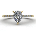 Calista engagement ring, featuring a brilliant natural pear-shaped diamond on an 18ct yellow gold band with diamond shoulders.