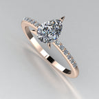 Front three-quarter studio view of the Calista diamond ring, highlighting the row of white pavé diamonds set beautifully into the warm rose gold shoulders.
