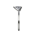 Side profile product photo of the Calista ring, displaying the secure, minimal three-prong claw basket setting holding the natural pear diamond.