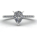 Hero shot of the Calista engagement ring, featuring a brilliant natural pear-shaped diamond on a polished white gold or platinum band with diamond shoulders.