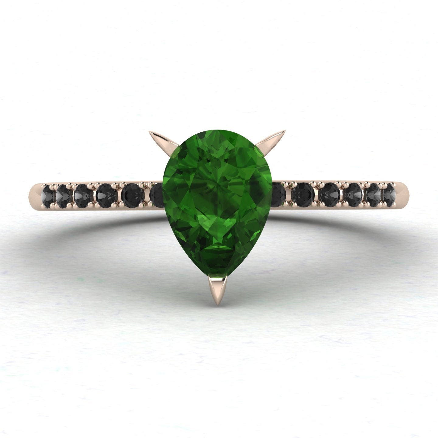 Top-down studio hero shot of the Calista engagement ring, featuring a vibrant pear-shaped green tourmaline on a rose gold band with black diamond shoulders.