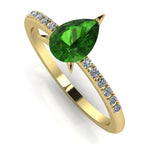 Front three-quarter studio view of the Calista tourmaline ring, showcasing the brilliant white pavé diamonds set into the warm yellow gold shoulders.