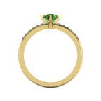 Through-finger view of the 18ct yellow gold green tourmaline ring, showing the smooth interior under-gallery and precise stone settings.