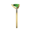 Side profile product photo of the Calista ring, displaying the clean, secure three-prong claw basket setting holding the pear green tourmaline.