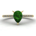 Front view of the Calista ring, featuring a vibrant pear-shaped green tourmaline on a polished 18ct yellow gold band with sparkling diamond shoulders.
