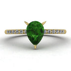 Front view of the Calista ring, featuring a vibrant pear-shaped green tourmaline on a polished 18ct yellow gold band with sparkling diamond shoulders.
