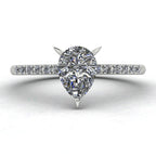 Close up image of the Calista engagement ring, showcasing a brilliant pear-shaped lab-grown diamond on a polished white gold or platinum band with diamond shoulders.