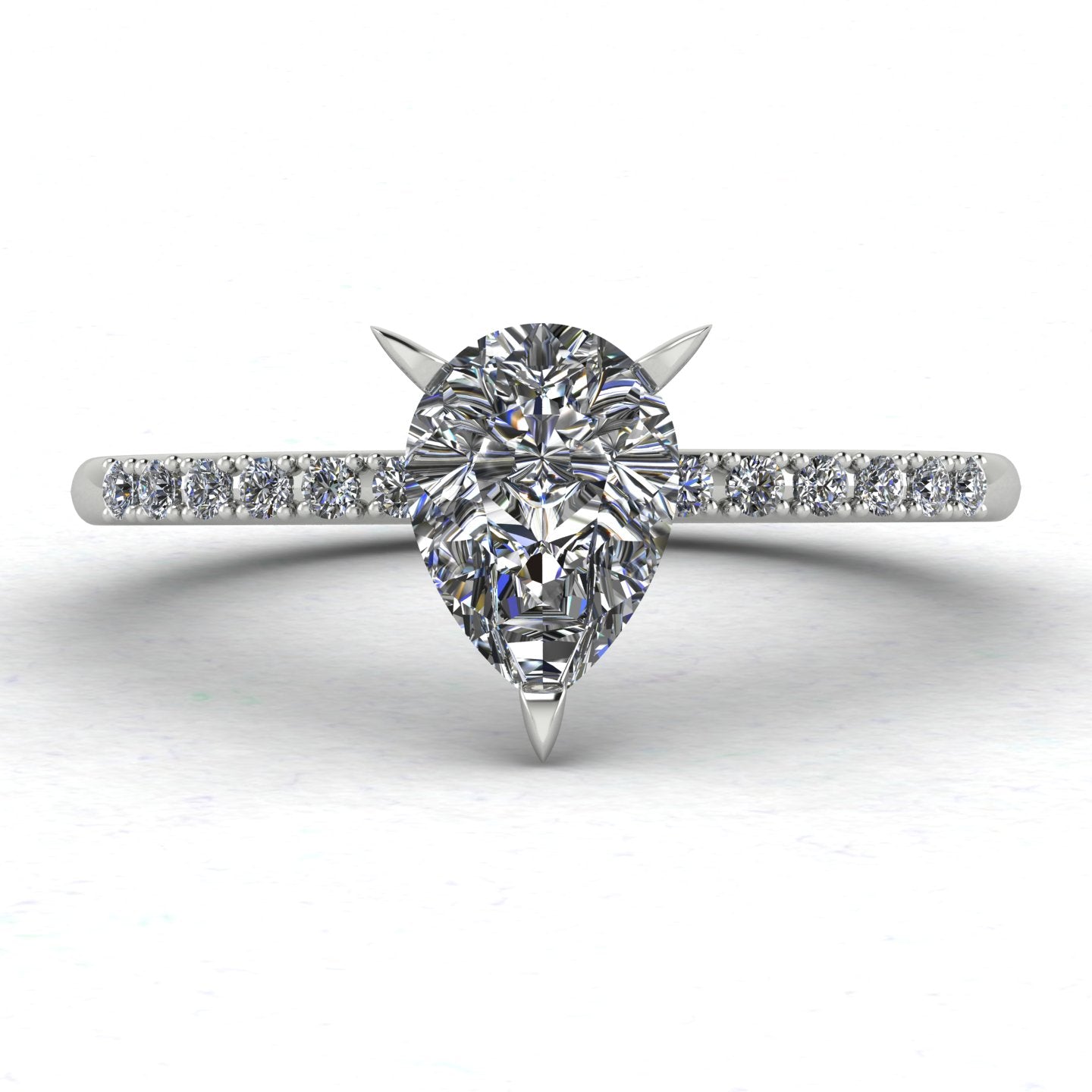 Close up image of the Calista engagement ring, showcasing a brilliant pear-shaped lab-grown diamond on a polished white gold or platinum band with diamond shoulders.