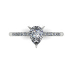 Top-down studio hero shot of the Calista engagement ring, showcasing a brilliant pear-shaped lab-grown diamond on a polished white gold or platinum band with diamond shoulders.