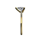 Side profile product photo of the Calista ring, displaying the clean, secure three-prong claw basket setting holding the pear lab diamond.
